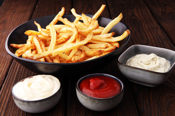 Red and white french fries chips with ketchup and mayonnaise