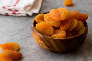 Dried Apricots in wooden Bowl.