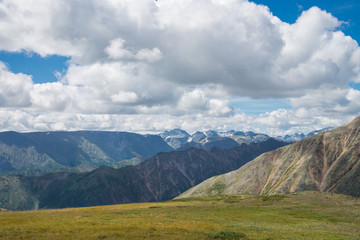 Obraz premium Summer Landscape of Eastern Sayan Mountains, scenic voew with cloudy sky. Russia, Siberia.