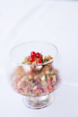 Beautiful and tasty dish in a glass on a white background