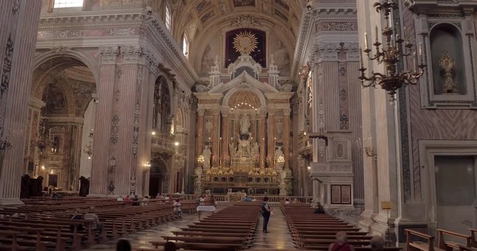 NAPLES, ITALY &ndash; JULY 2016 : Video shot of Church of Ges&ugrave; Nuovo interior on a sunny day with statues and people in view