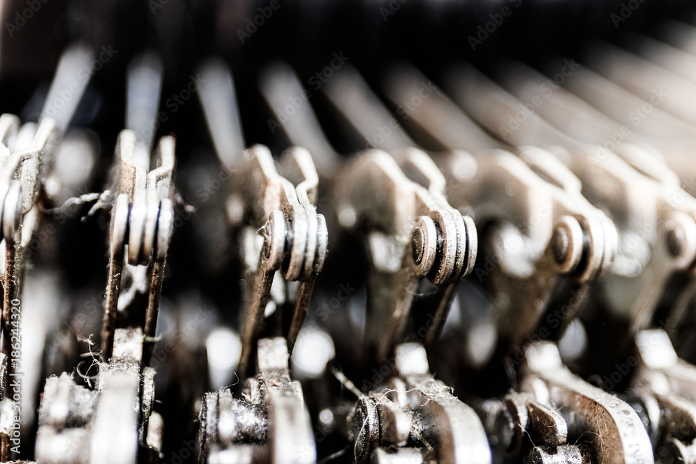Fototapete antique typewriter mechanical typebar slide. each key connects to a lever that when pressed, moves a