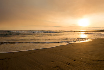 The calm sea in a very cloudy sunset