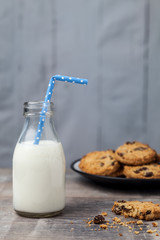 Small bottle of milk with Blue straw and cookies