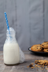 Small bottle of milk with Blue straw and cookies