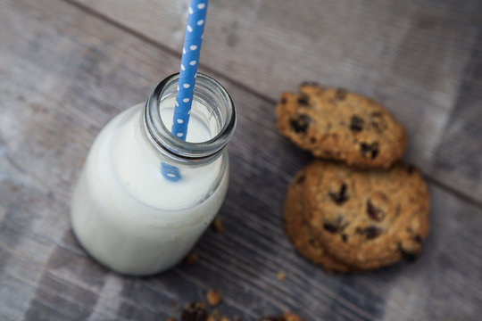 Small bottle of milk with Blue straw and cookies