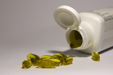 Fish oil capsule white background, health care and medical concept