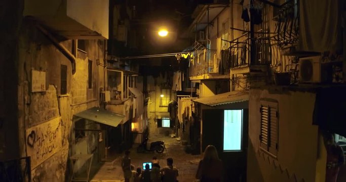 NAPLES, ITALY &ndash; JULY 2016 : Video shot of narrow backstreet at night with people in view