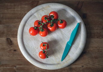 Tomaten und Messer auf einem Brett