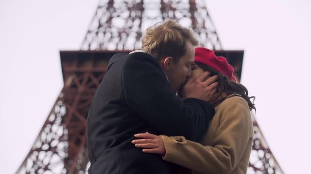 Handsome man tenderly kissing his beloved woman saying goodbye, painful breakup