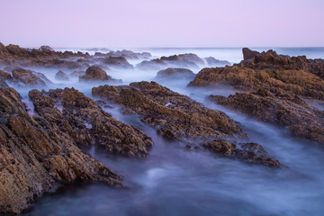 Milky Sea Water over Rocks at the Coast