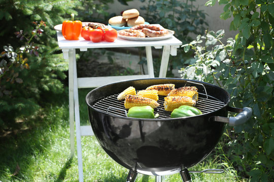 Barbecue grill with tasty vegetables on backyard