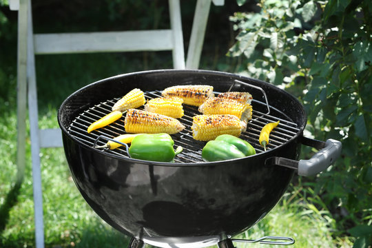 Barbecue grill with tasty vegetables on backyard