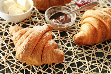 Tasty croissants on table, closeup