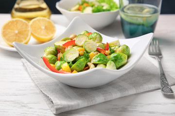 Plate of tasty salad with Brussels sprouts on table