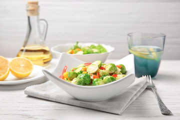 Plate of tasty salad with Brussels sprouts on table