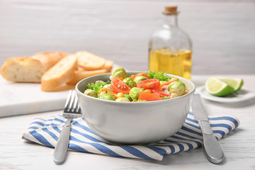Bowl of tasty salad with Brussels sprouts on table