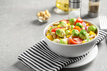 Bowl with yummy brussel sprouts salad on table