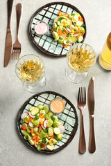 Plates with yummy brussel sprouts salad on table