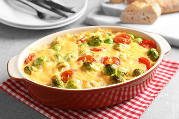 Baking dish with yummy brussel sprouts casserole on table