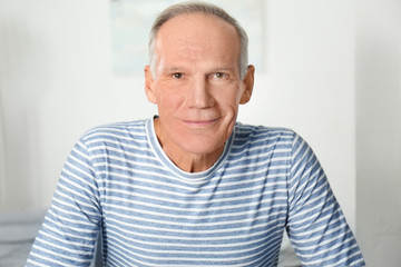 Attractive mature man in casual clothes indoors