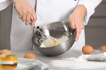Chef preparing dough for pastries in kitchen