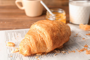 Fresh yummy croissant on table, closeup