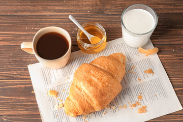 Fresh yummy croissant served for breakfast on wooden table