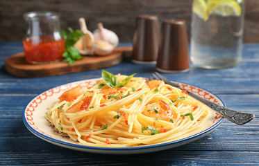 Delicious pasta with garlic and fried shrimps on plate