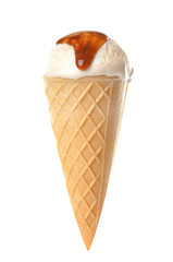 Waffle cone with ice cream and caramel sauce on white background