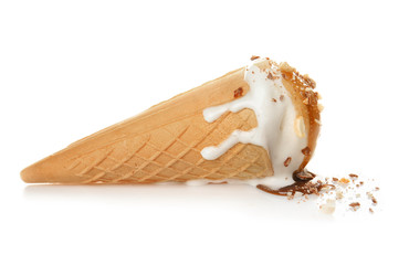 Waffle cone with ice cream and caramel sauce on white background