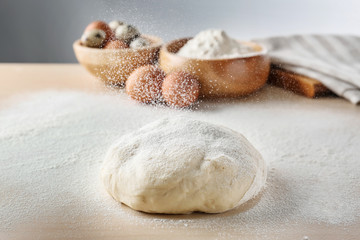 Scattering flour on dough