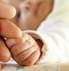 mother holding little baby's hand stock photo