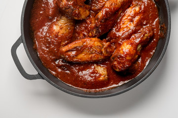 Chicken Wings and Legs in iron pan. Fast food menu background. Flat top view, from above. Isolated.