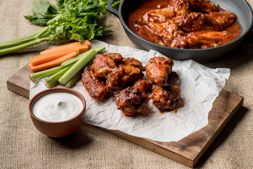 Buffalo chicken wings cooking. Food background.