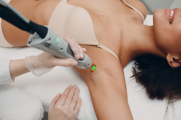 Laser epilation and cosmetology. Hair removal cosmetology procedure. Laser epilation and cosmetology. Cosmetology and SPA concept. - obrazy, fototapety, plakaty