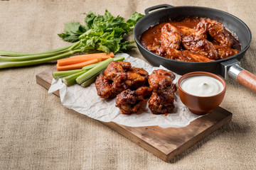 Buffalo chicken wings cooking. Food background.