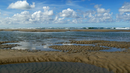 Spettacolare spiaggia deserta con nuvole nel cielo azzurro