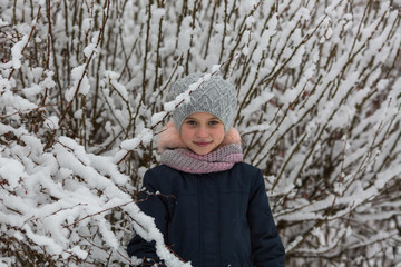 Portrait of little girl in winter Park.