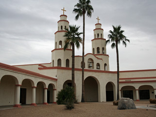 Fototapeta premium Church bell towers highlighted by 3 palm trees
