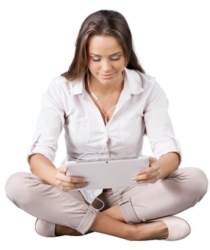 Young woman listening music from digital tablet
