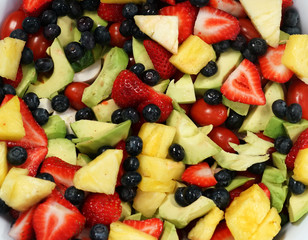 Close up on mixed fruit salad as food background