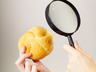 Bun bread roll and magnifying glass