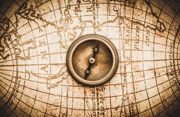 Closeup of an Old Compass on an Old Map