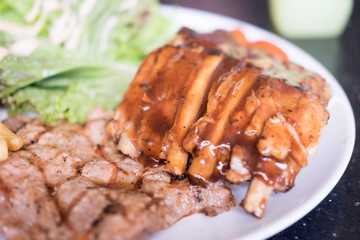 Grilled ribeye steaks and roasted pork steak.