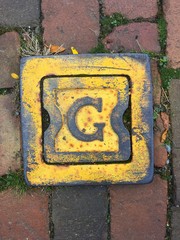 Yellow G Symbol on the Brick Sidewalk in Boston
