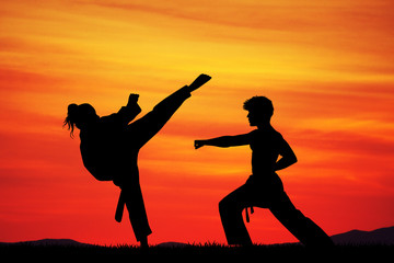 man and woman doing karate at sunset © adrenalinapura