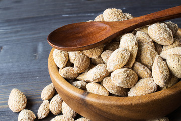 Salted almonds in the peel. A traditional snack for beer. Selective focus. Horizontal.