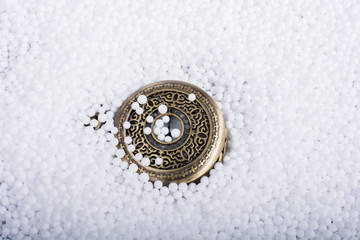 Pocket watch on white polystyrene foam balls
