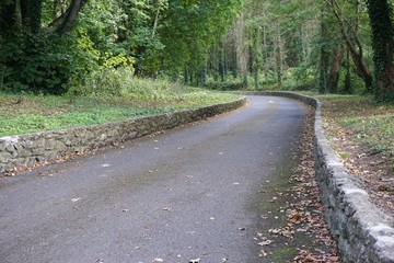 Stone lined roadway curves into the distance